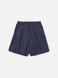 The Navy Peached Poplin Pleated Track Short is shown as a flat lay against a white background. The shorts feature a single pleat on the front, an elasticated waistband with a button closure, and two side hand pockets. The navy cotton fabric has a smooth, peached finish.