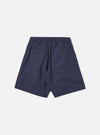 The Navy Peached Poplin Pleated Track Short is shown from the back as a flat lay against a plain white background. The shorts feature an elasticated waistband and a single rear patch pocket on the right side. The navy blue cotton fabric has a smooth, soft peached finish.