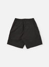 The Black Recycled Polytech Pleated Track Short is shown from the back as a flat lay against a plain white background. The image highlights the elasticated waistband and the two rear patch pockets. The smooth, black recycled polytech fabric features visible tonal stitching.
