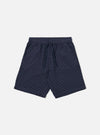 The Navy Dot Waffle Simple Short is shown as a flat lay against a plain white background. The shorts feature a textured waffle knit fabric in navy blue with a subtle dot pattern, an elasticated waistband with a matching drawstring, and two side pockets. The design is simple with a relaxed fit and straight hems.