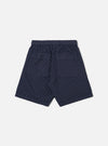 The Navy Dot Waffle Simple Short is shown from the back as a flat lay against a plain white background. The image highlights the elasticated waistband and a single rear patch pocket on the right side. The navy blue fabric features a distinct, textured waffle knit pattern with small dot-like indentations.