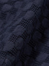 A close-up swatch image of the Navy Dot Waffle Simple Short fabric highlights a deep navy blue color with a distinct waffle knit texture. The fabric features a pattern of small, raised circular dots evenly spaced across the textured surface.