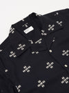The Black Embroidered Diamond Camp Shirt is shown as a flat lay against a plain white background. The shirt features a camp collar, short sleeves, and two chest patch pockets. A contrasting grey diamond embroidery design is visible across the front panels of the black fabric.