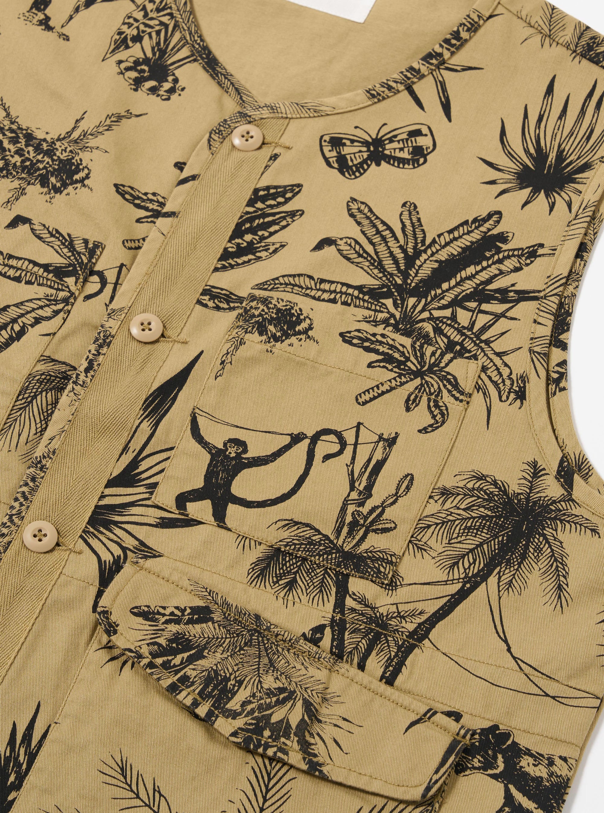 The Sand Jungle Toile Twill 4 Pocket Gilet is shown from the back against a plain white background. The gilet features a loose, relaxed fit with a straight hem and a simple neckline. The fabric is a sand-colored twill featuring a tonal jungle toile print throughout.