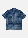 The Indigo Block Print Circles Camper Shirt is shown as a flat lay against a plain white background. The shirt features a relaxed camp collar, a button-down front, and a single chest pocket. The dark indigo cotton fabric is decorated with an all-over white hand-block printed pattern consisting of repetitive concentric circles.