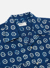The Indigo Block Print Circles Camper Shirt is shown from the back as a flat lay against a plain white background. The shirt features an all-over white circle pattern on a deep indigo base, a straight hem, and short sleeves. The fabric's block-print texture and the simple construction of the back panel are clearly visible.