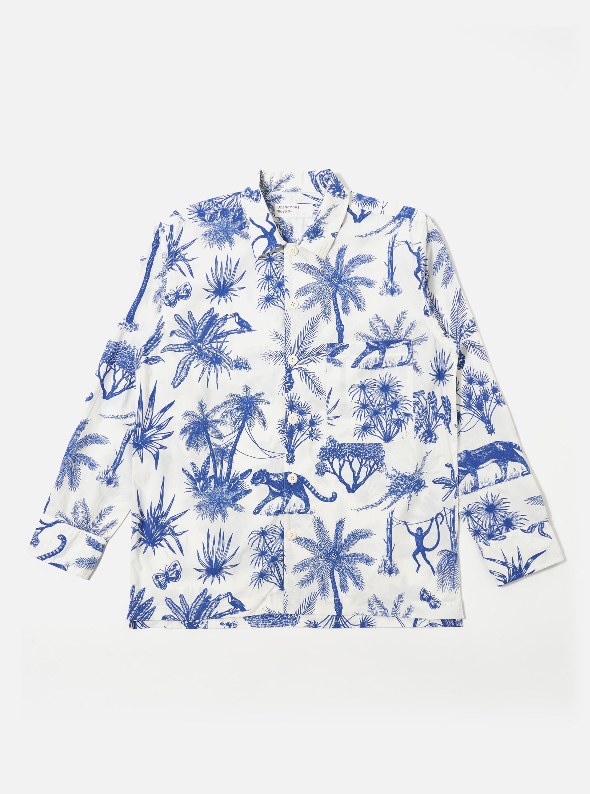 The White Jungle Toile Poplin Fatigue Shirt is shown as a flat lay against a white background. The shirt features an all-over dark jungle toile print with animal and botanical motifs on a white base. It has a one-piece collar, a single large square patch pocket on the chest, and a five-button front closure with oversized buttons.