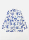 The White Jungle Toile Poplin Fatigue Shirt is shown from the back as a flat lay against a plain white background. The image highlights the shirt's relaxed fit, straight hem, and the detailed jungle toile print featuring green botanical and animal motifs on a white base.