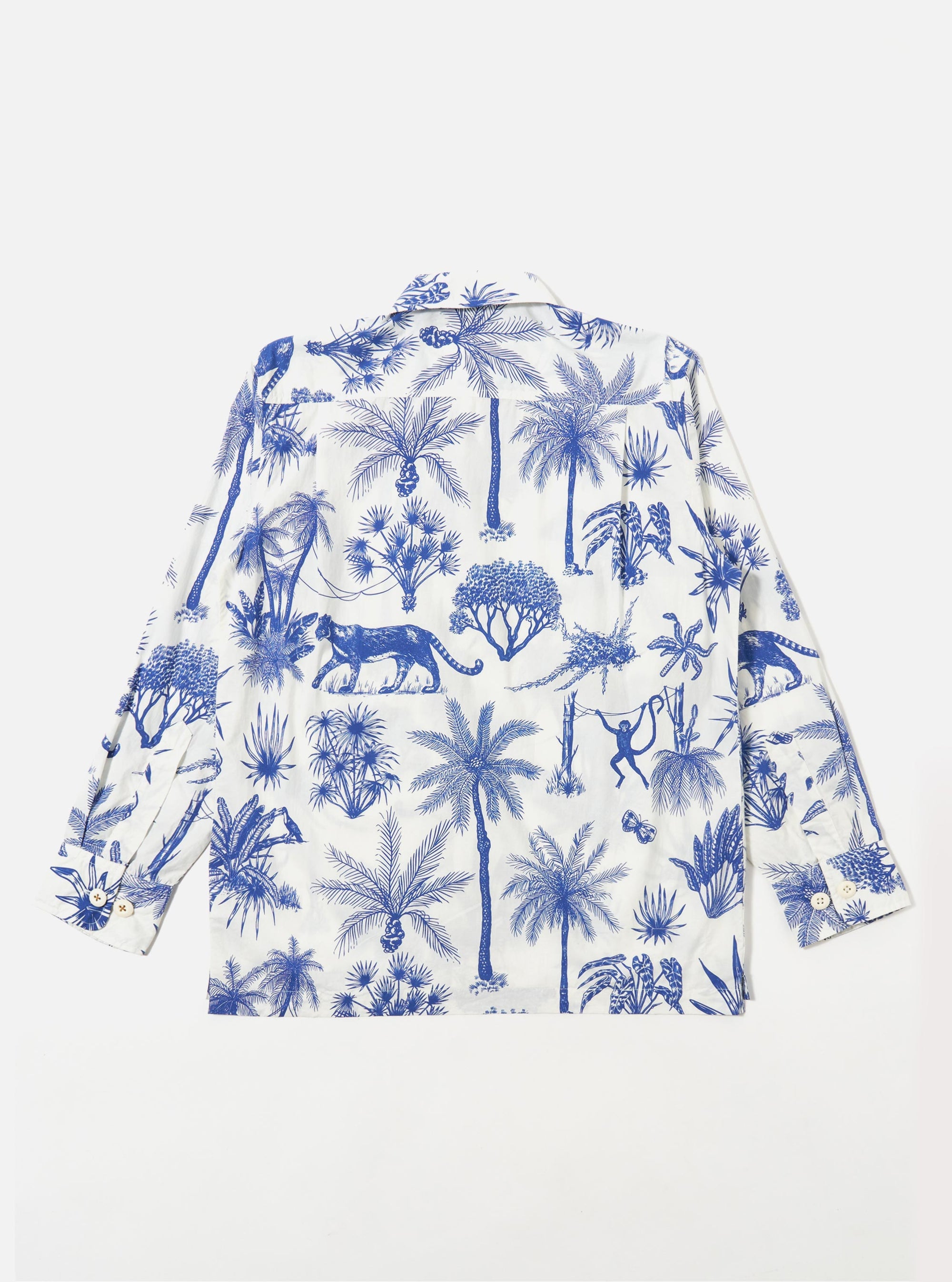 The White Jungle Toile Poplin Fatigue Shirt is shown from the back as a flat lay against a plain white background. The image highlights the shirt's relaxed fit, straight hem, and the detailed jungle toile print featuring green botanical and animal motifs on a white base.