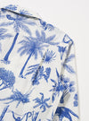 The White Jungle Toile Poplin Fatigue Shirt is shown from the back as a flat lay against a plain white background. The image highlights the shirt's straight-cut hem and the detailed jungle toile print, which features dark illustrations of wildlife and tropical flora on a white base.