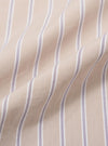 A close-up fabric swatch of the Sand Urban Stripe Lazy Day Shirt displays a pattern of vertical sand-colored and white stripes. The image focuses on the fine texture and weave of the cotton material. No model or mannequin is present.