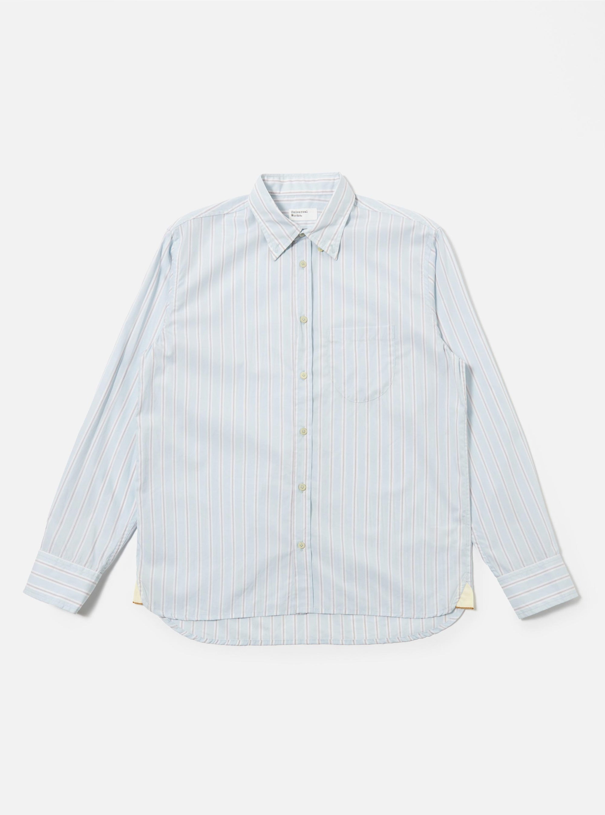 The Sky Urban Stripe Lazy Day Shirt is shown as a flat lay against a white background. The shirt features a light blue and white vertical stripe pattern, a button-down collar, a single chest pocket on the left side, and a full button-up front.
