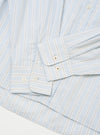 The Sky Urban Stripe Lazy Day Shirt is shown in a close-up detail shot as a flat lay against a plain white background. The image focuses on the upper portion of the shirt, highlighting the collar, the top buttons of the placket, and the fine blue and white vertical stripe pattern of the fabric.