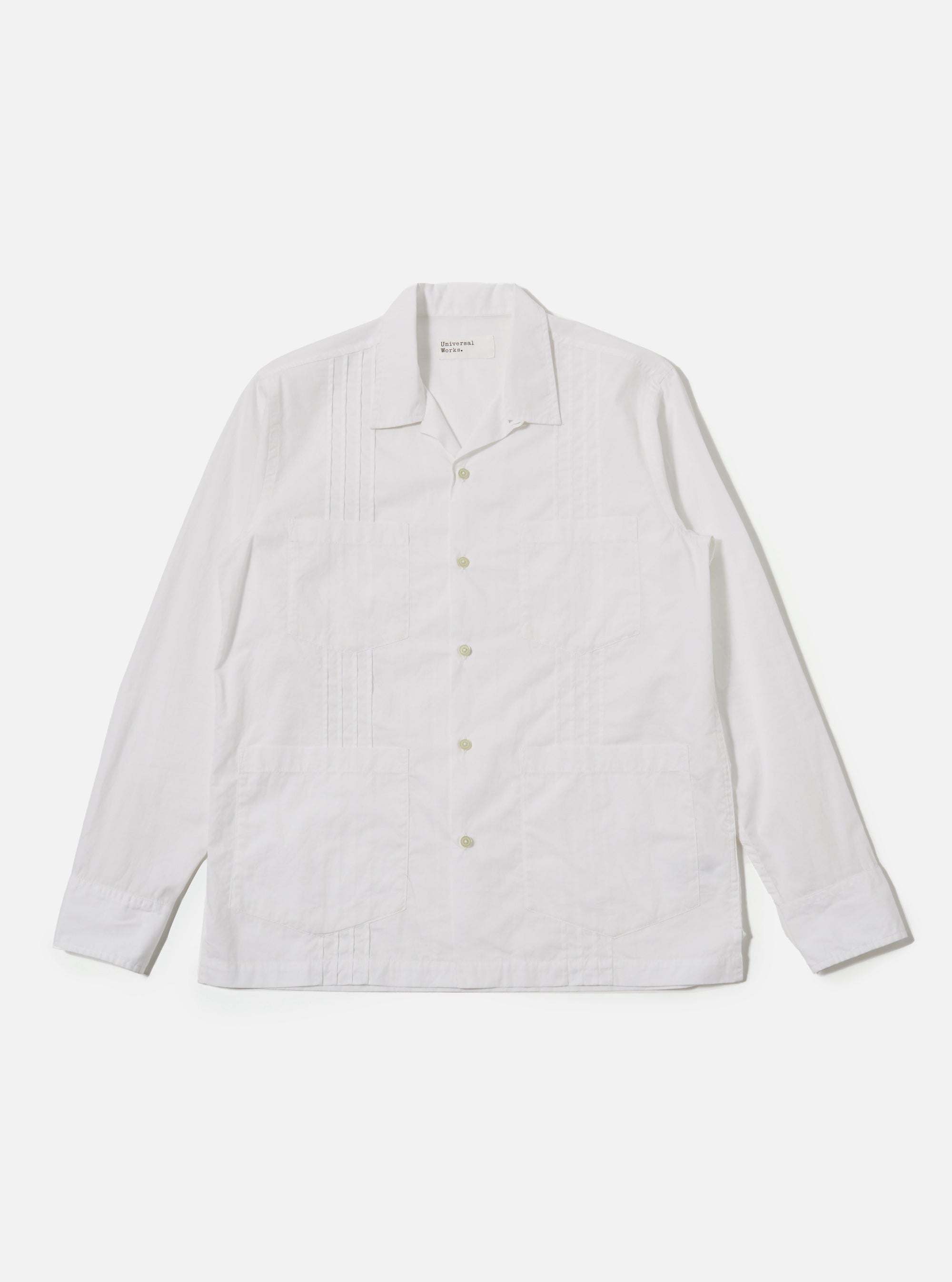 The White Poplin Dwight Overshirt is shown as a flat lay against a plain white background. The overshirt features a relaxed camp collar, a full button-front closure, and two large utility-style patch pockets on the chest. The fabric is a crisp white cotton poplin.