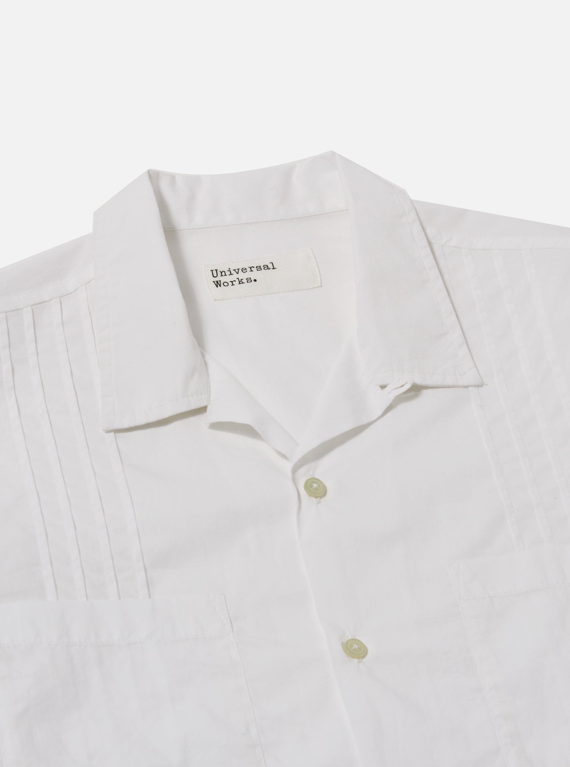 The White Poplin Dwight Overshirt is shown from the back as a flat lay against a plain white background. The image highlights the clean construction of the shoulders and the straight hem of the garment. The white poplin fabric appears smooth and lightweight.