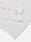 The White Poplin Dwight Overshirt is shown in a detail view as a flat lay against a white background. This view focuses on the lower portion of the garment, showcasing the straight hem and two of the four front patch pockets. The crisp white cotton poplin fabric features a smooth texture.