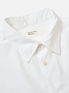 The White Poplin Patched Lazy Day Shirt is shown as a flat lay against a white background. The shirt features a classic pointed collar, a full button-down front, and two large patch pockets at the chest and hip. The fabric is a smooth cotton poplin in an off-white ecru shade.