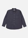 The Navy Poplin Patched Lazy Day Shirt is shown as a flat lay against a white background. The shirt is a deep navy blue and features a classic button-down collar, a full-button front, and long sleeves with buttoned cuffs. A prominent feature is the single asymmetrical patch pocket on the chest. The fabric has a smooth poplin texture.