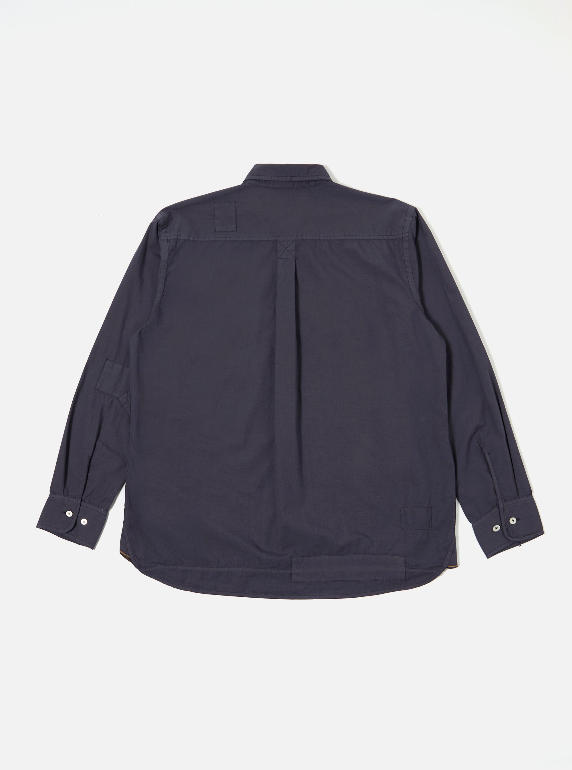 The Navy Poplin Patched Lazy Day Shirt is shown from the back as a flat lay against a plain white background. The image highlights the shirt's relaxed construction and tonal paneling, featuring a clean back yoke and the smooth texture of the navy poplin cotton.