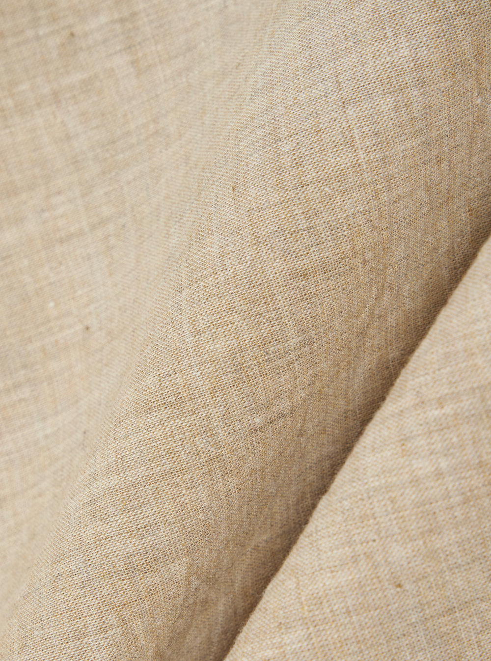 A close-up fabric swatch of the Beige Fine Organic Cotton Sal Road Shirt highlights the soft marled texture and lightweight loose weave of the organic cotton material. The image focuses on the blended beige threads and the detailed construction of the fabric.