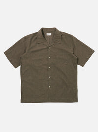 The Brown Fine Organic Cotton Sal Road Shirt is shown as a flat lay against a white background. The shirt features a relaxed camp collar, a button-down front, and short sleeves. A single patch pocket is visible on the chest. The fabric is a smooth, lightweight organic cotton in a solid brown color.