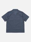 The Indigo Fine Organic Cotton Sal Road Shirt is shown from the back as a flat lay against a plain white background. The image highlights the clean construction of the shirt's rear panel, the simple straight hem, and the deep blue indigo color of the fine organic cotton fabric.