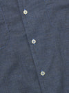 The Indigo Fine Organic Cotton Sal Road Shirt is shown from the back as a flat lay against a plain white background. The image highlights the shirt's straight hem, short sleeves, and the deep indigo color of the fine organic cotton fabric.