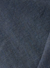 A close-up swatch of the Indigo Fine Organic Cotton Sal Road Shirt highlights the deep indigo blue color and the soft marled texture of the lightweight, loose-weave organic cotton fabric.