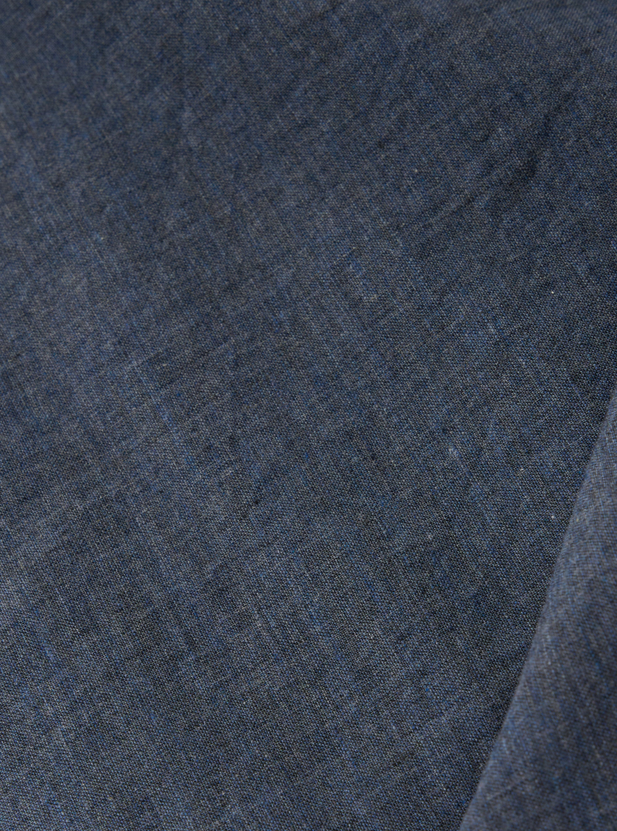 A close-up swatch of the Indigo Fine Organic Cotton Sal Road Shirt highlights the deep indigo blue color and the soft marled texture of the lightweight, loose-weave organic cotton fabric.