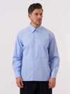 A model wears the Sky Fil A Fil Square Pocket Shirt against a plain, light-colored background. The shirt is a light sky blue with a fine end-on-end texture and features a prominent oversized square pocket on the left chest, a button-down front, and a classic collar.