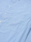 The Sky Fil A Fil Square Pocket Shirt is shown as a flat lay against a white background. The shirt features a large, oversized square chest pocket on the left side, a button-front fastening, and a pointed collar. The fabric is a light sky blue with a visible fil-a-fil weave.