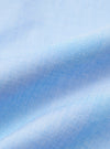 A close-up fabric swatch of the Sky Fil A Fil Square Pocket Shirt shows a fine, textured weave in a pale blue color. The fabric has a subtle, heathered appearance typical of fil-a-fil material.