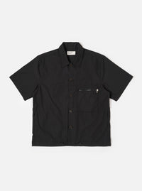The Black Recycled Polytech Z Tech Overshirt is shown as a flat lay against a white background. The overshirt features a one-piece collar, a central button-down closure, and a visible zip-closure patch pocket on the left chest. The black recycled polytech fabric has a smooth finish.