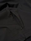 The Black Recycled Polytech Z Tech Overshirt is shown from the back as a flat lay against a plain white background. The image highlights the garment's clean, black recycled polytech fabric, a straight hem, and a back yoke with a central box pleat.