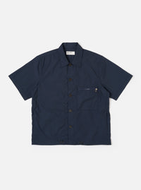 The Navy Recycled Polytech Z Tech Overshirt is shown as a flat lay against a white background. The short-sleeve overshirt features a boxy silhouette, a one-piece collar, and a full button-down front. A prominent reinforced patch pocket with a visible zipper is located on the left chest. The fabric is a smooth, dark navy recycled polytech.