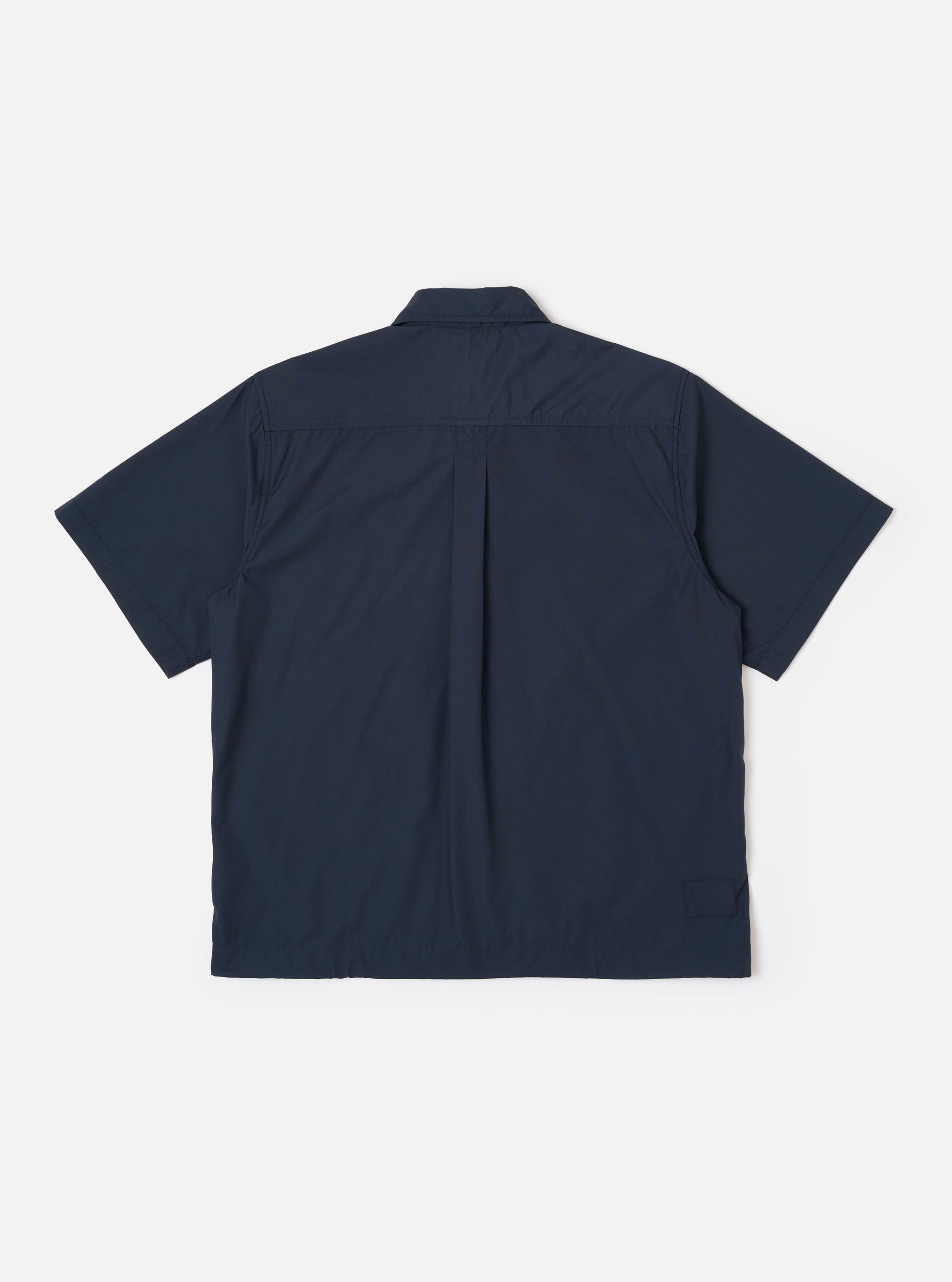 The Navy Recycled Polytech Z Tech Overshirt is shown from the back as a flat lay against a plain white background. The image highlights the clean, straight-cut back panel and the smooth finish of the navy blue recycled polytech fabric.