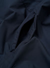 The Navy Recycled Polytech Z Tech Overshirt is shown as a flat lay against a plain white background. The image provides a detailed view of the short-sleeve overshirt, highlighting the smooth technical fabric and the reinforced patch chest pocket with its prominent vertical zipper. The garment features a simple one-piece collar and a full-length button placket.
