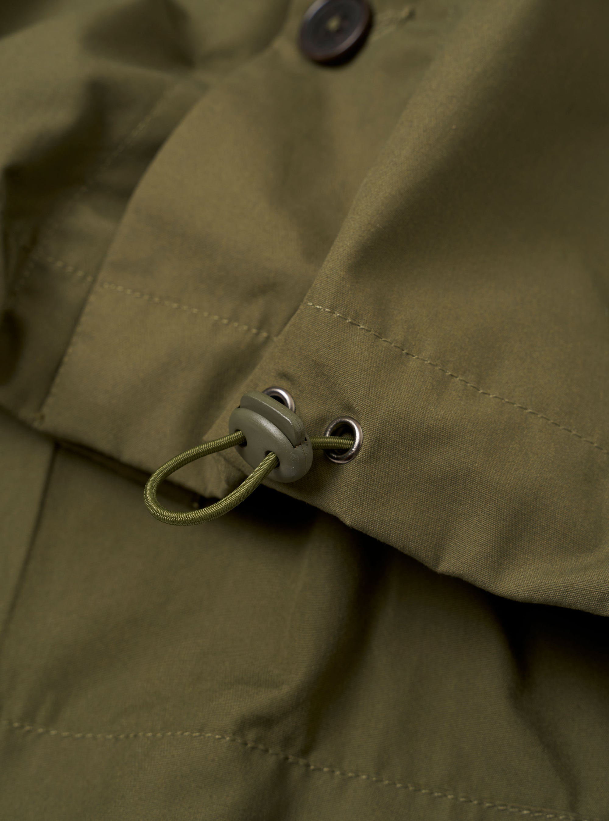 The Olive Recycled Polytech Z Tech Overshirt is shown from the back as a flat lay against a plain white background. The image highlights the clean construction of the garment's rear panel, the smooth olive green fabric, and the straight hemline.
