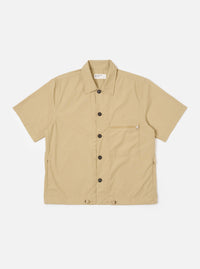 The Sand Recycled Polytech Z Tech Overshirt is shown as a flat lay against a white background. The overshirt features a one-piece collar, a central front closure, and a single reinforced vertical zip pocket on the left chest. The sand-colored fabric has a smooth, technical finish, and the garment is designed with a boxy fit and a straight hem.