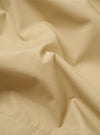 The Sand Recycled Polytech Z Tech Overshirt is presented as a flat lay against a plain white background. The overshirt features a classic collar, a central zip-front closure, and utility-style patch pockets on the chest. The recycled polytech fabric has a smooth, technical finish in a light sand color.