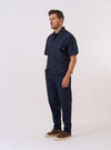The Navy Recycled Polytech Z Tech Overshirt is shown as a flat lay against a white background. The overshirt features a classic collar, a central button-down closure, and two large patch pockets on the chest. The garment is made from a smooth navy blue recycled polytech fabric.