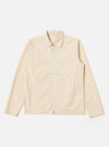 The Stone Seo Recycled Nylon Zip Too Shirt is shown as a flat lay against a plain white background. The shirt features a full-length central zip closure, a classic pointed collar, and two large patch pockets at the waist. The garment is made from a smooth, stone-colored recycled nylon fabric with visible tonal stitching.