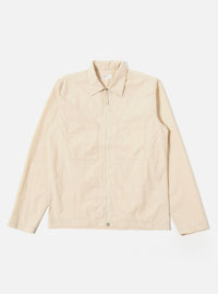 The Stone Seo Recycled Nylon Zip Too Shirt is shown as a flat lay against a plain white background. The shirt features a full-length central zip closure, a classic pointed collar, and two large patch pockets at the waist. The garment is made from a smooth, stone-colored recycled nylon fabric with visible tonal stitching.