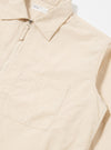 The Stone Seo Recycled Nylon Zip Too Shirt is shown in a detail view as a flat lay against a plain white background. The image highlights the smooth, technical texture of the stone-colored recycled nylon fabric and the construction of a chest patch pocket.
