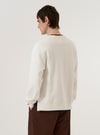 A model is wearing the Ecru Brush Back Sweat Billy Sweat, shown from the back against a plain white background. The sweatshirt features a relaxed fit with dropped shoulders, a ribbed crew neck, and ribbed detailing at the cuffs and hem. The garment is made from a solid ecru-colored fabric with a smooth finish. No mannequin is present in the image.