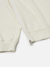 The Ecru Brush Back Sweat Billy Sweat is shown from the back as a flat lay against a plain white background. The image highlights the off-white color and soft texture of the garment, featuring a ribbed crew neck and a ribbed hem.