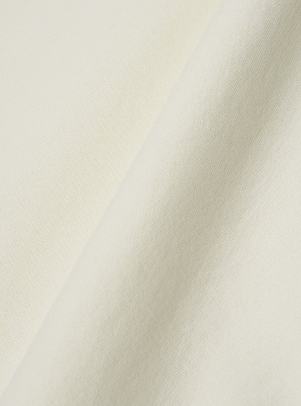 A close-up swatch image of the Ecru Brush Back Sweat Billy Sweat fabric. The image focuses on the textile detail, showing a clean ecru color with the soft, fuzzy texture of the brushed-back cotton sweat material.