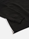 The Black Brush Back Sweat Billy Sweat is shown in a detail view as a flat lay against a plain white background. The image highlights the soft, brushed texture of the black cotton fabric and the ribbed detailing at the collar.