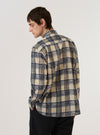 A model is wearing the Navy Window Panes Square Pocket Shirt against a plain white background. The shirt features a dark navy base with a large-scale white windowpane check pattern, a classic button-down front, and a prominent square patch pocket on the left chest. The model is shown from the waist up, wearing the shirt with the top button open for a relaxed look.