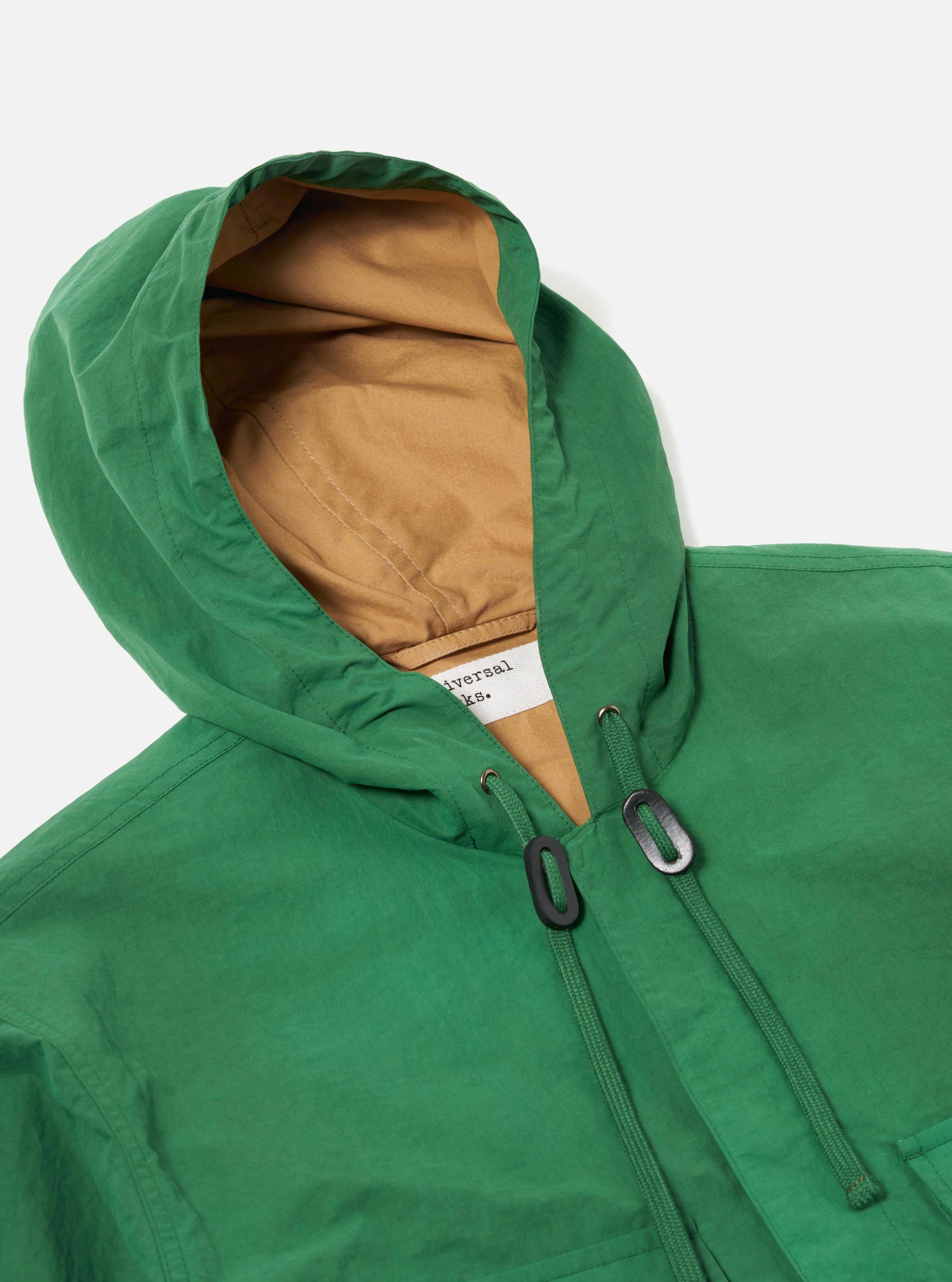 The Green Recycled Splash Nylon Longsands Jacket is shown from the back as a flat lay against a plain white background. The image highlights the jacket's hooded design, a straight hem, and a simple one-piece back panel. The green recycled splash nylon fabric has a smooth, technical finish.